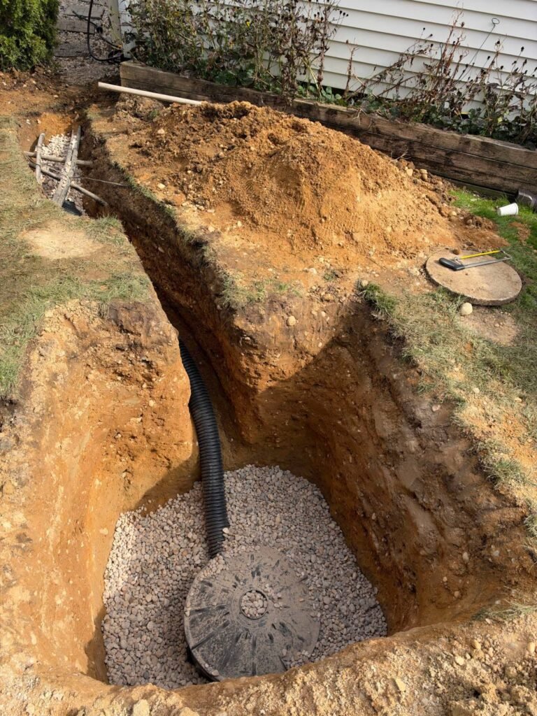 Completed dry well seated in gravel with the inlet pipe connected